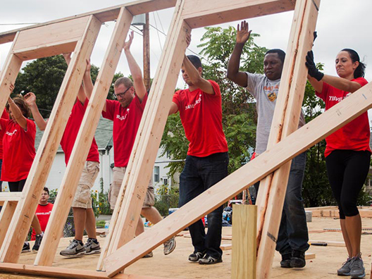 Volunteers building framing for a new home.