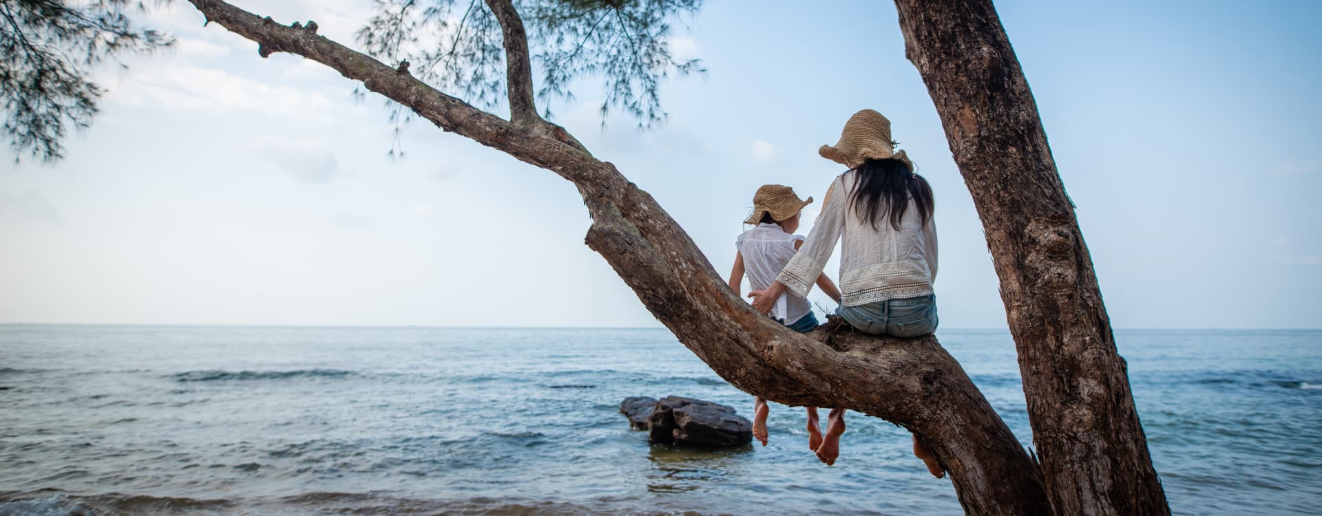 Girl and Mom are sitting on a tree