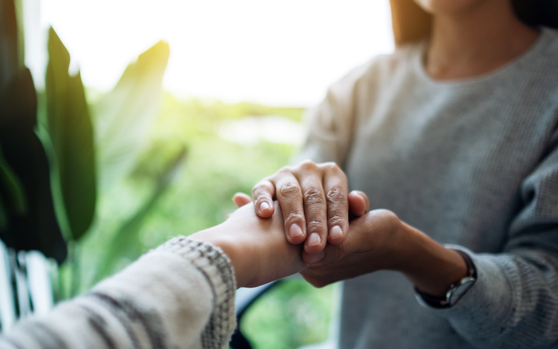 Person comforting someone's hands