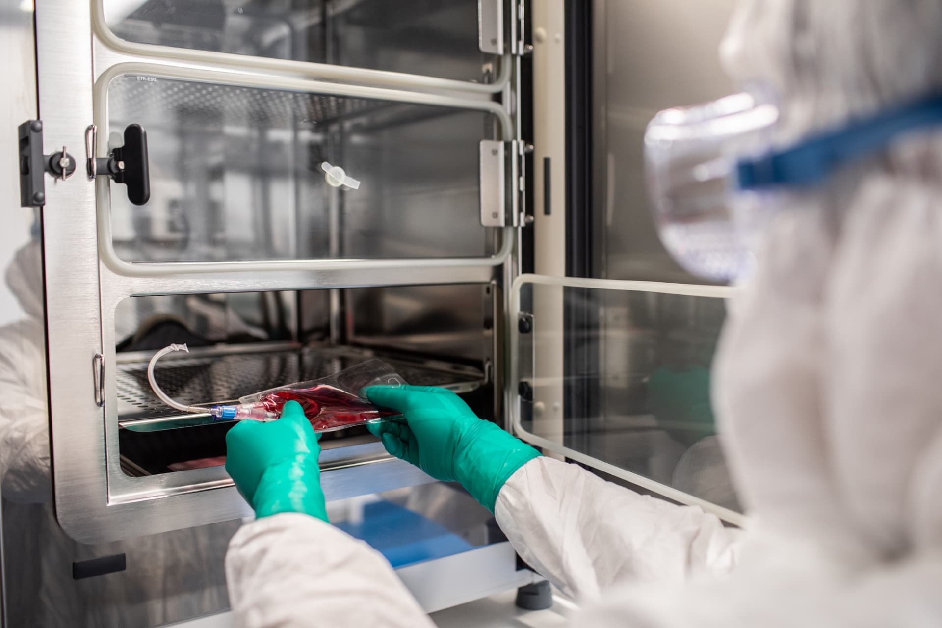 Scientist collecting bloodl bag