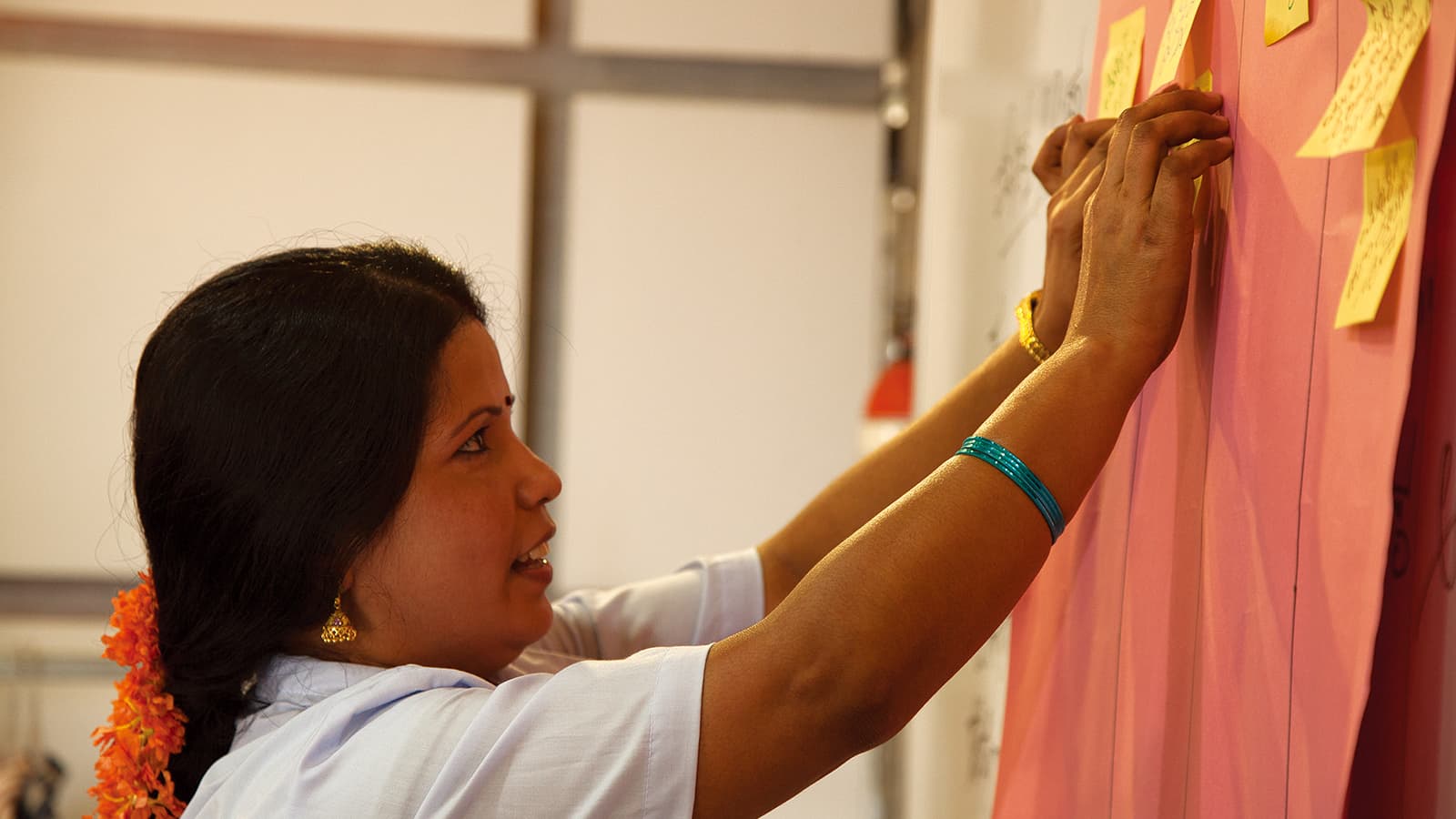 Woman hanging a piece of paper