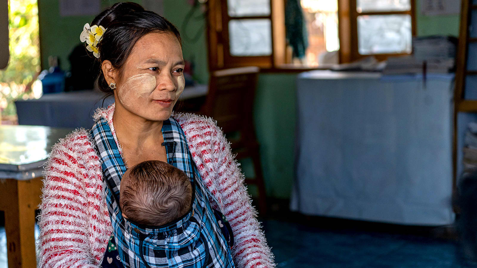 Mother carrying child in carry bag