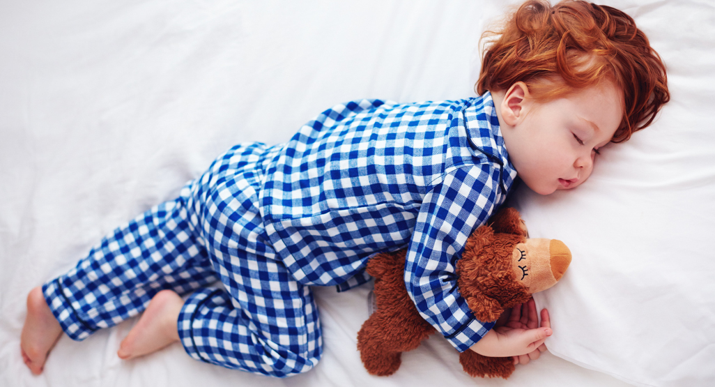 young boy asleep on the bed