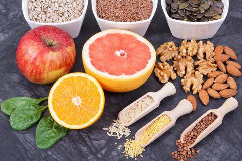 Assorted fruits, nuts and seeds in bowls and on table