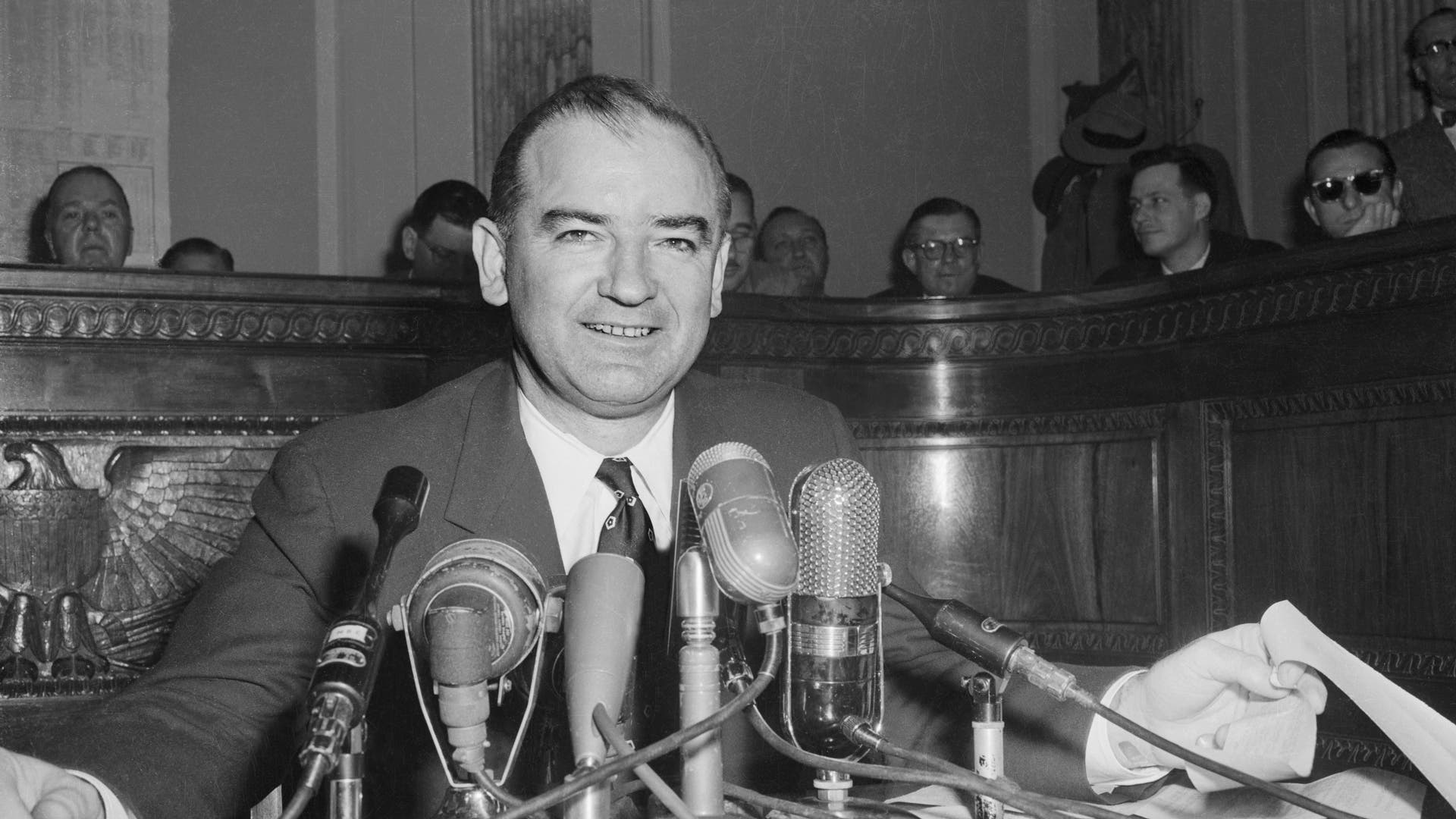Senator McCarthy Attending US Army Hearings (Original Caption) Senator Joseph R. McCarthy chairman of the Senate Investigations Subcommittee, is shown as he took center stage again to comment on the latest developments in his dispute with the White House and Army Secretary Robert T. Stevens.