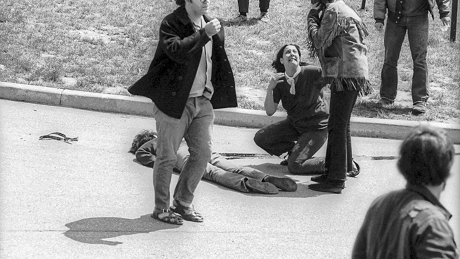 As others call for help, teenager Mary Ann Vecchio (center) kneels beside the body of Kent State University student Jeffrey Miller (1950 - 1970) who had been shot during an anti-war demonstration on the university campus, Kent, Ohio, May 4, 1970.