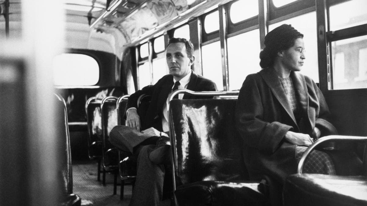 Rosa Parks sitting in the front of a bus in Montgomery, Alabama, after the Supreme Court ruled segregation illegal on the city bus system on December 21st, 1956. (Credit: Bettmann Archive/Getty Images)