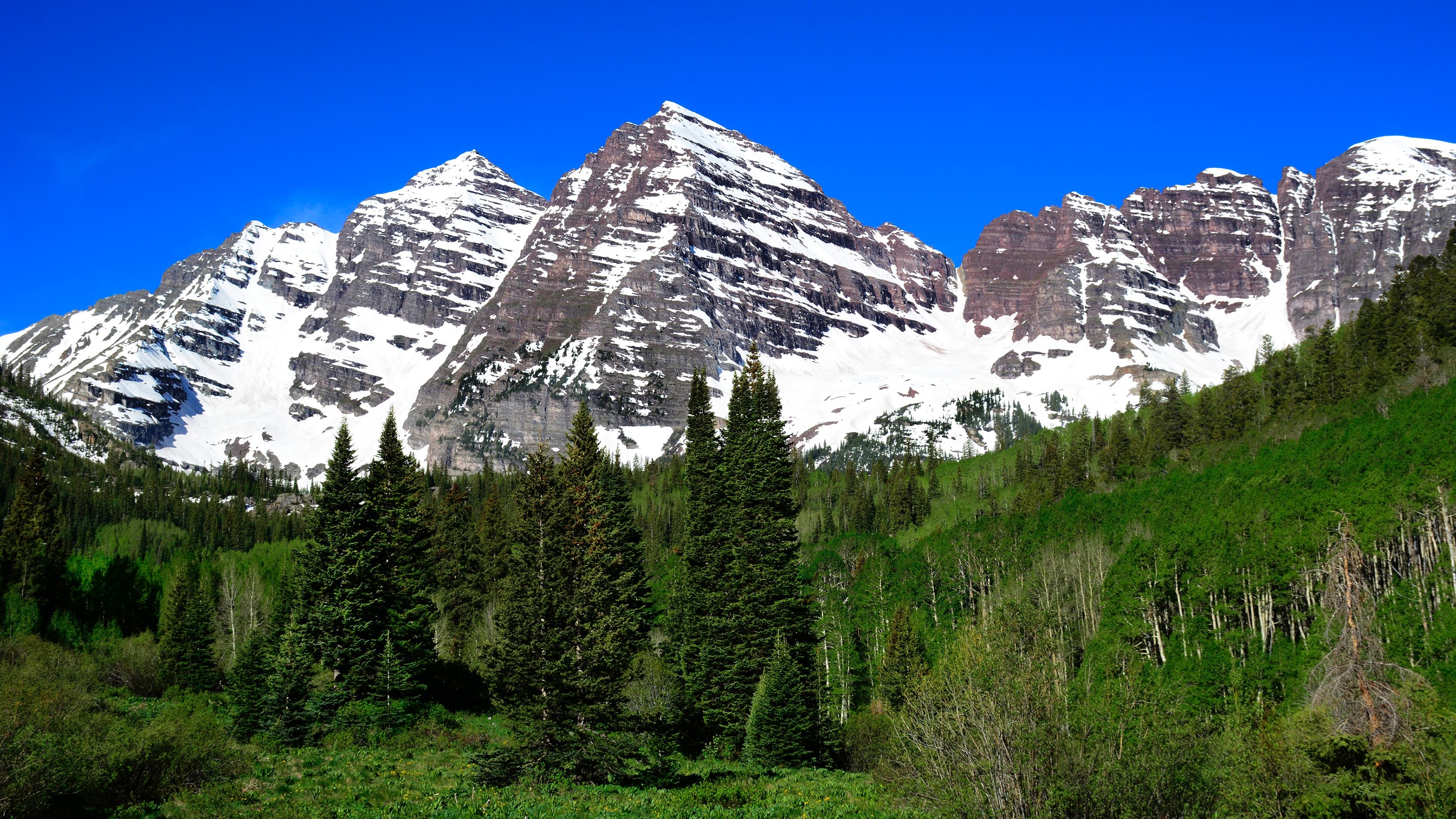 The Maroon Bells near Aspen, Colorado, are two peaks in the Elk Mountains - Maroon Peak and North Maroon Peak. They are located in the Maroon Bells-Snowmass Wilderness of White River National Forest.