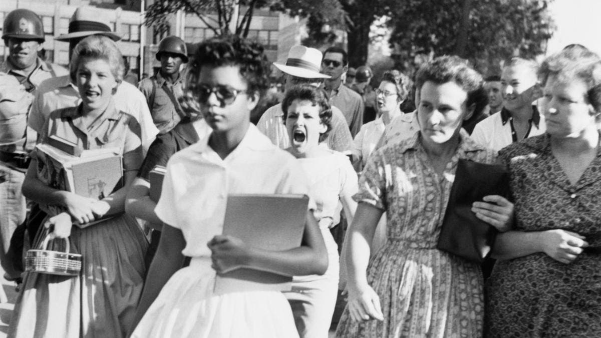 Elizabeth Eckford ignores the hostile screams and stares of fellow students on her first day of school. She was one of the nine negro students whose integration into Little Rock's Central High School was ordered by a Federal Court following legal action by NAACP. (Credit: Bettmann Archive/Getty Images)