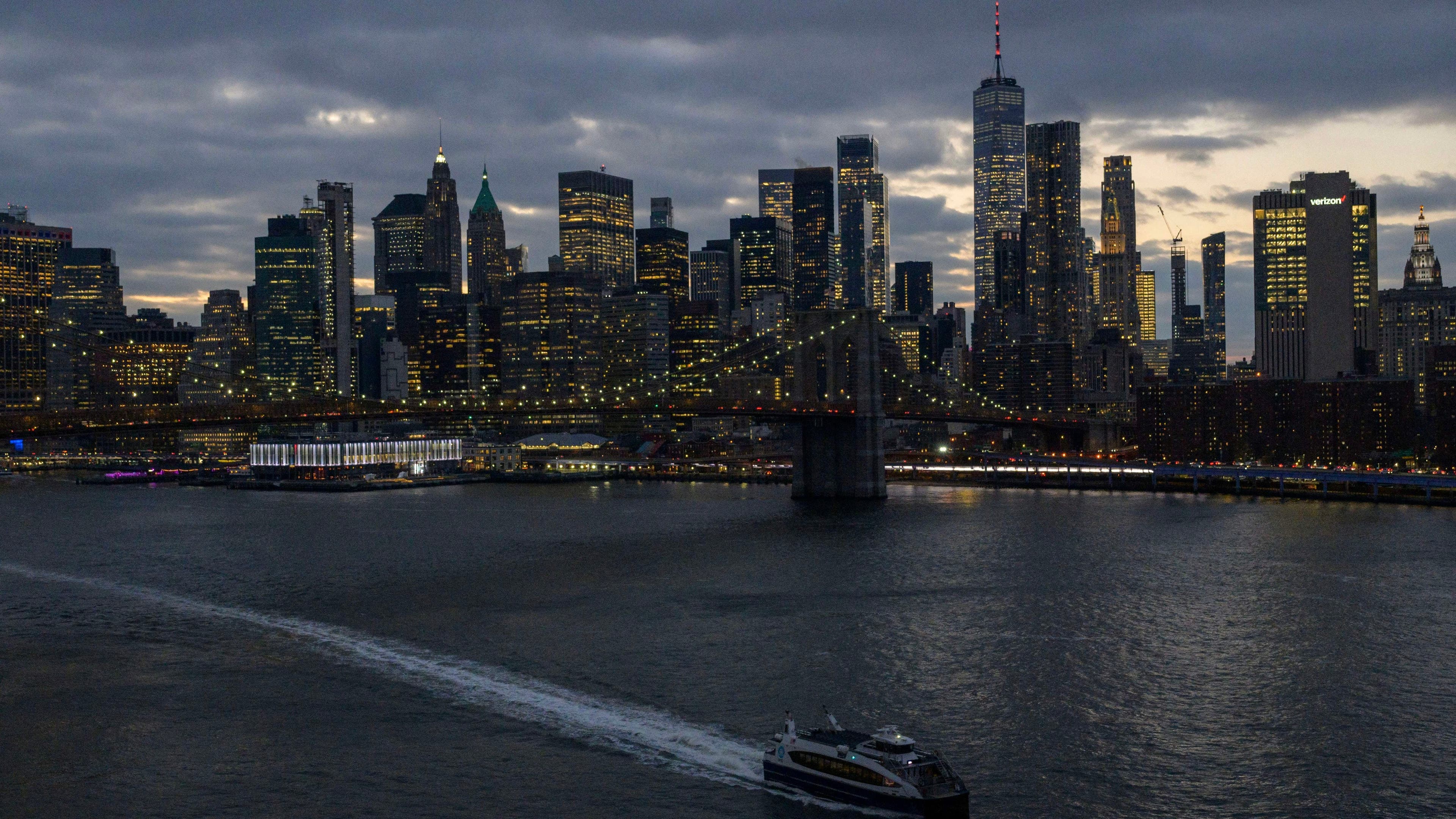 The skyline of lower Manhattan is seen past a ferry on the East River in New York City on February 06, 2023.