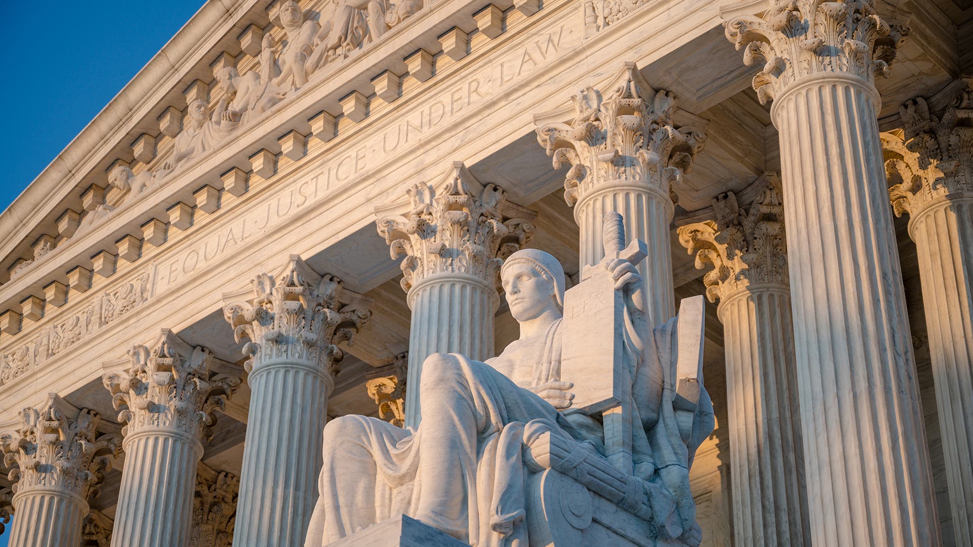 Exterior of Supreme Court of the United States on First Street in Washington, D.C., with statue by James Earle Fraser titled Authority of Law.