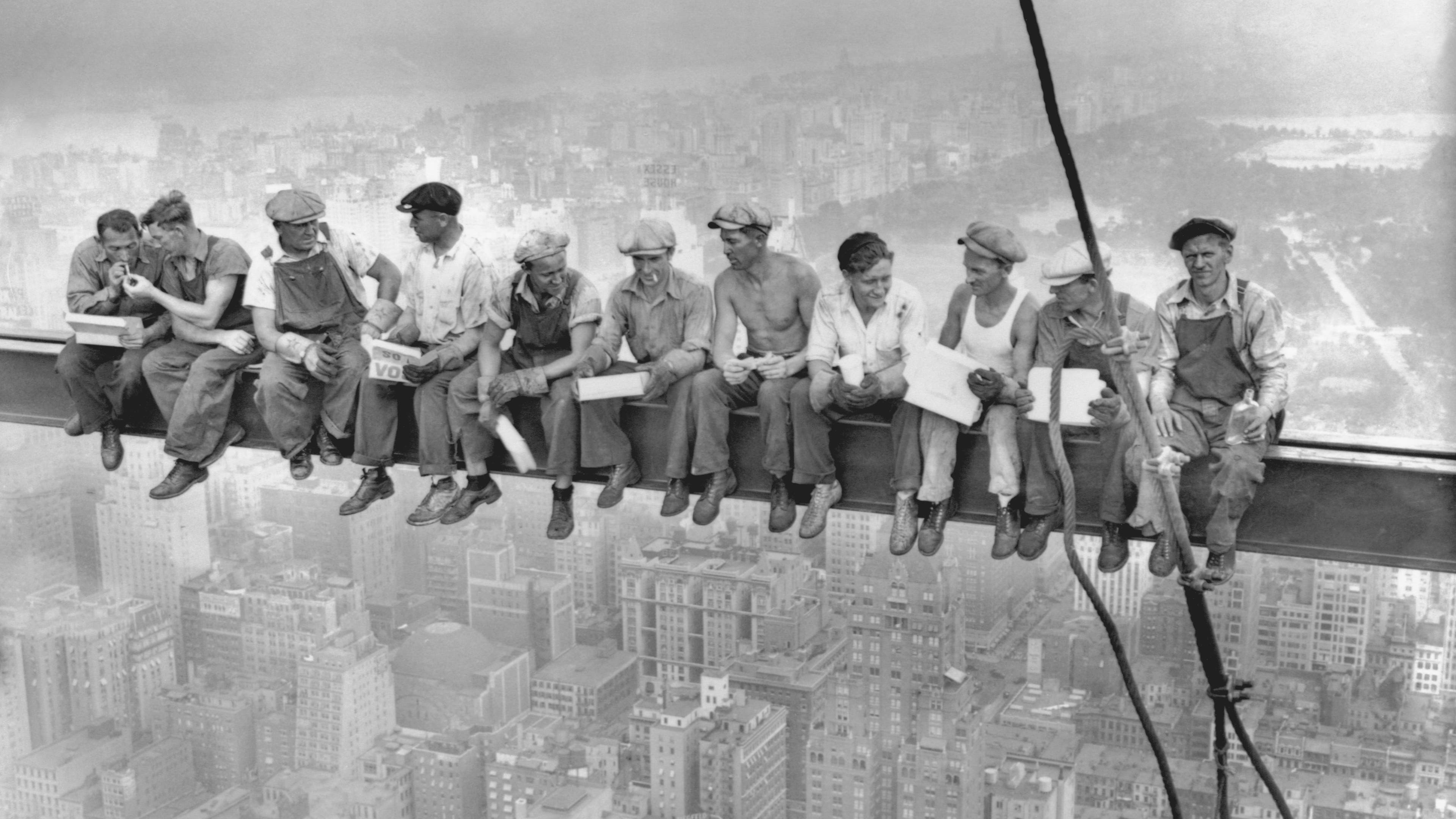 September 1932: Steel workers atop the 70 story RCA building in NYC's Rockefeller Center get all the air and freedom they want by lunching on a steel beam with a sheer drop of over 800 feet to the street level.