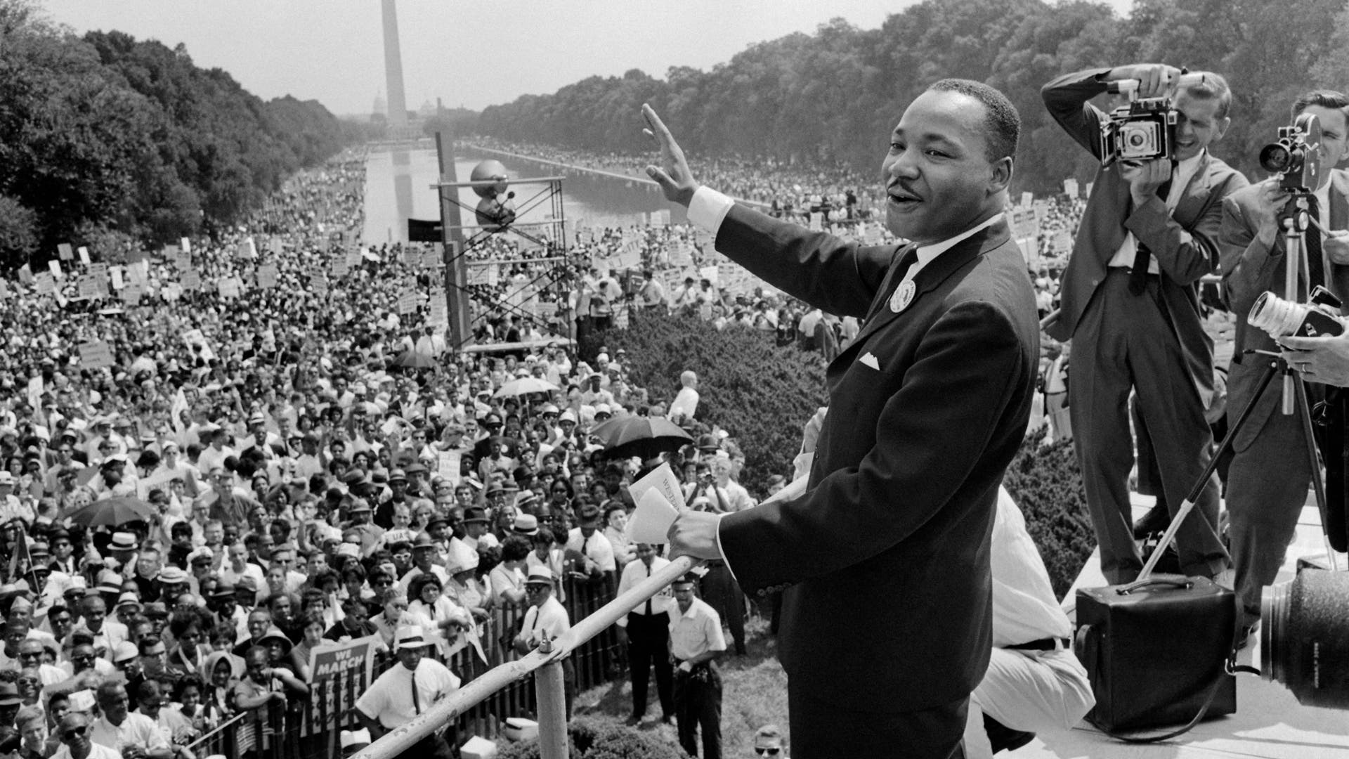 TOPSHOT-BIO-MARTIN LUTHER KING-MARCH ON WASHINGTONTOPSHOT - The civil rights leader Martin Luther King (C) waves to supporters 28 August 1963 on the Mall in Washington DC (Washington Monument in background) during the "March on Washington". - King said the march was "the greatest demonstration of freedom in the history of the United States." Martin Luther King was assassinated on 04 April 1968 in Memphis, Tennessee. James Earl Ray confessed to shooting King and was sentenced to 99 years in prison. King's killing sent shock waves through American society at the time, and is still regarded as a landmark event in recent US history. AFP PHOTO (Photo by AFP) (Photo by -/AFP via Getty Images)