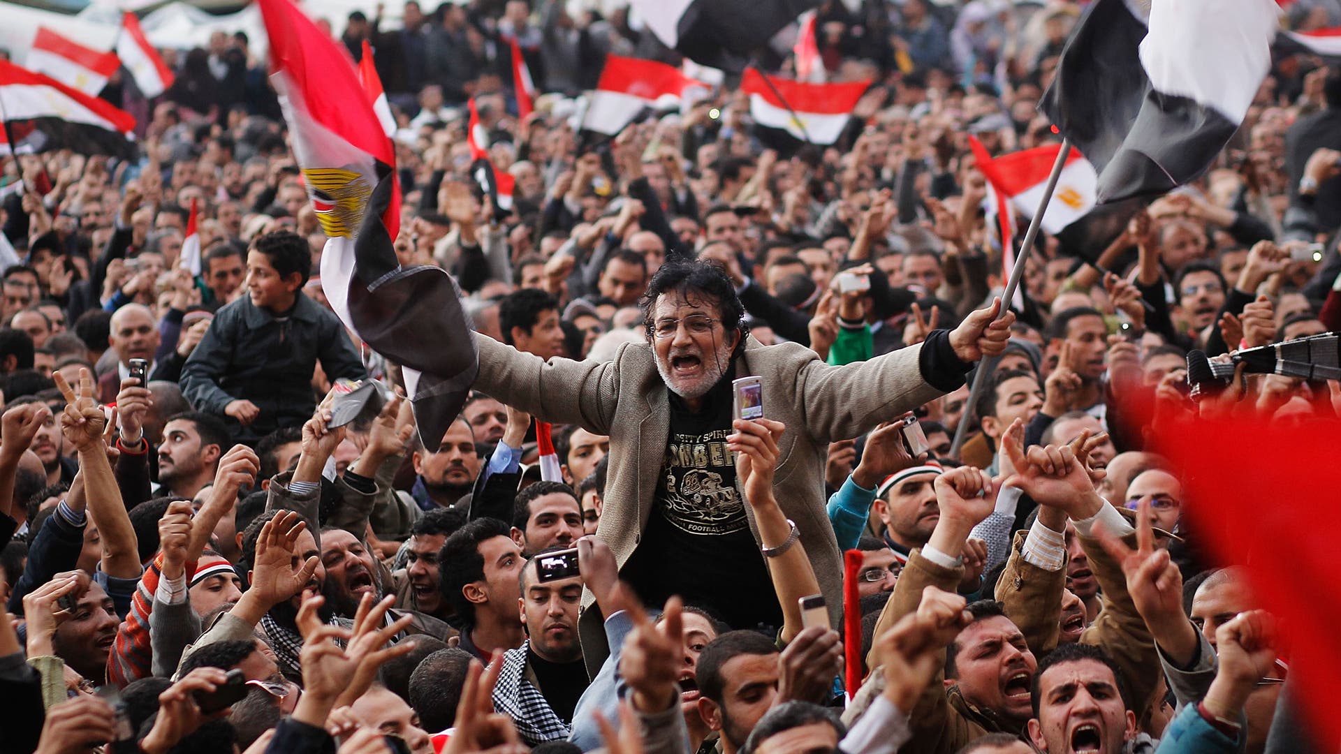 Crowds In Tahrir Square As Mubarak Prepares To Address Egyptians CAIRO, EGYPT - FEBRUARY 10: An anti-government protester is carried on shoulders in Tahrir Square in the afternoon before a speech by Egyptian President Hosni Mubarak in Tahrir Square February 10, 2011 in Cairo, Egypt. President Hosni Mubarak made a statement saying that he had given some powers to his vice President but would not resign or leave the country, leaving a crowd of anti-government protesters disappointed and furious after early reports he might step down. (Photo by Chris Hondros/Getty Images)