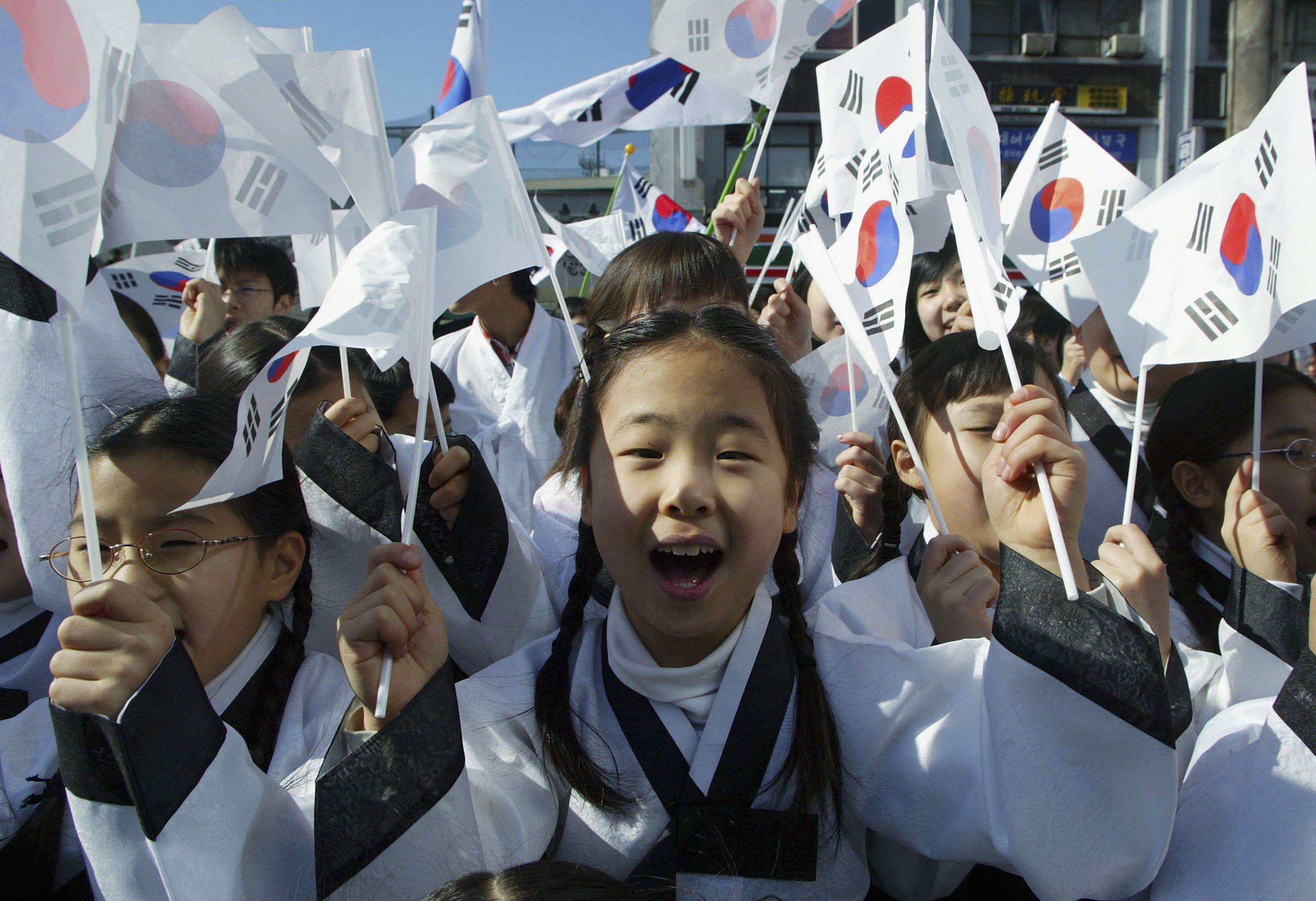 SEOUL, SOUTH KOREA - MARCH 1: South Korean children wearing traditional costume wave national flags during the celebration of The March First Independence Movement Anniversary on March 1, 2005 in Seoul, South Korea. South Koreans celebrate the public holiday a day of remembrance to mark the 1919 civilian uprising against Japanese colonial rule from 1910-1945. A legacy of resentment and territorial disputes between the nations were renewed when the Japanese ambassador claimed last week, that Japan was the rightful owner of several largely uninhabited islands claimed by both Tokyo and Seoul. (Photo by Chung Sung-Jun/Getty Images)