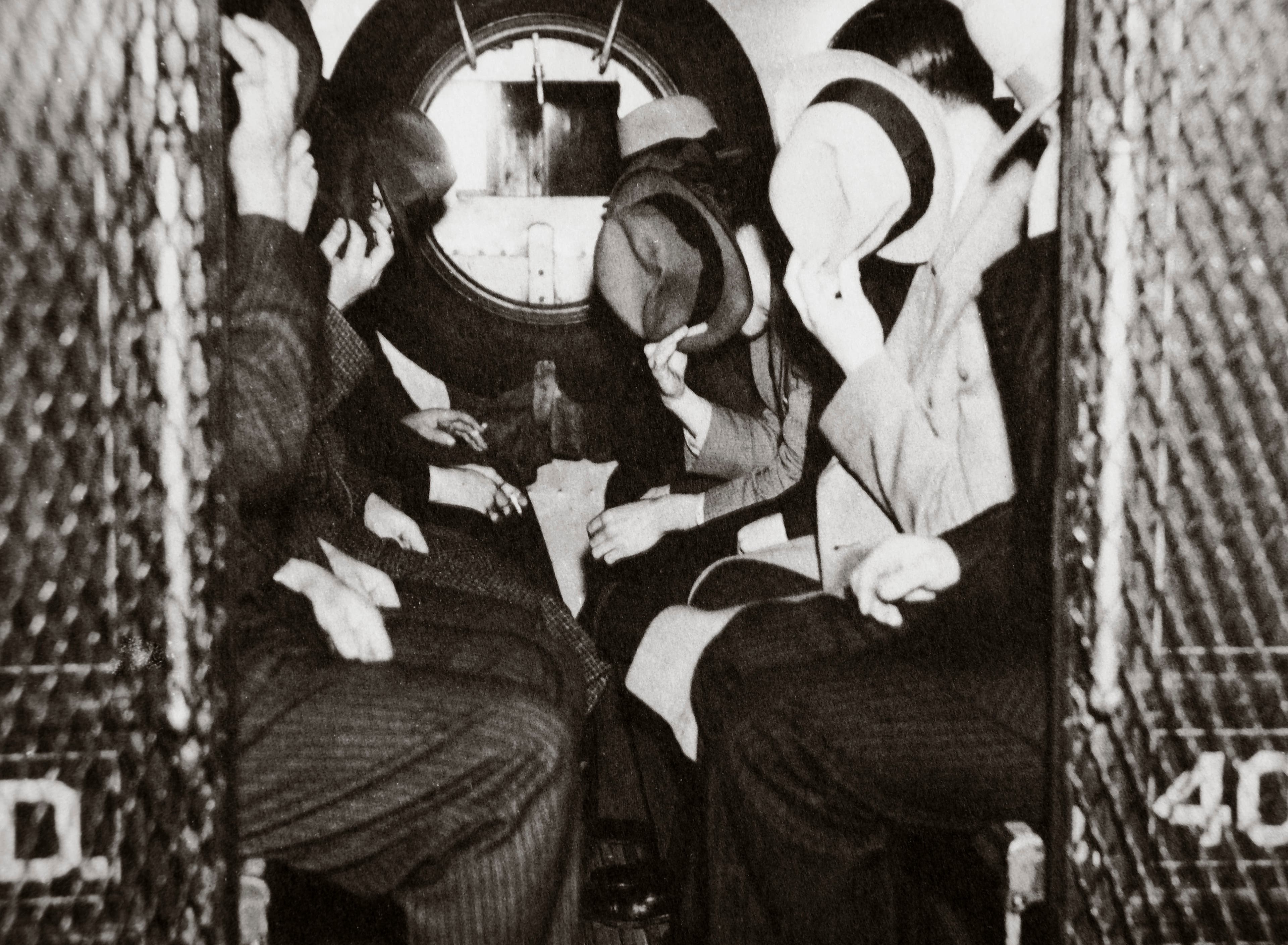 Gangsters in a patrol wagon, New York, USA, mid 1930s. Hiding their faces from the camera as they are on their way to the office of Special Prosecutor Thomas E Dewey. Dewey (1902-1971) was appointed Special Prosecutor to lead the fight against crime and corruption in New York. He later went on to serve as Governor of the state of New York (1943-1954) and was the unsuccessful Republican candidate for the US Presidency in 1944 and 1948. (Photo by Historica Graphica Collection/Heritage Images/Getty Images)