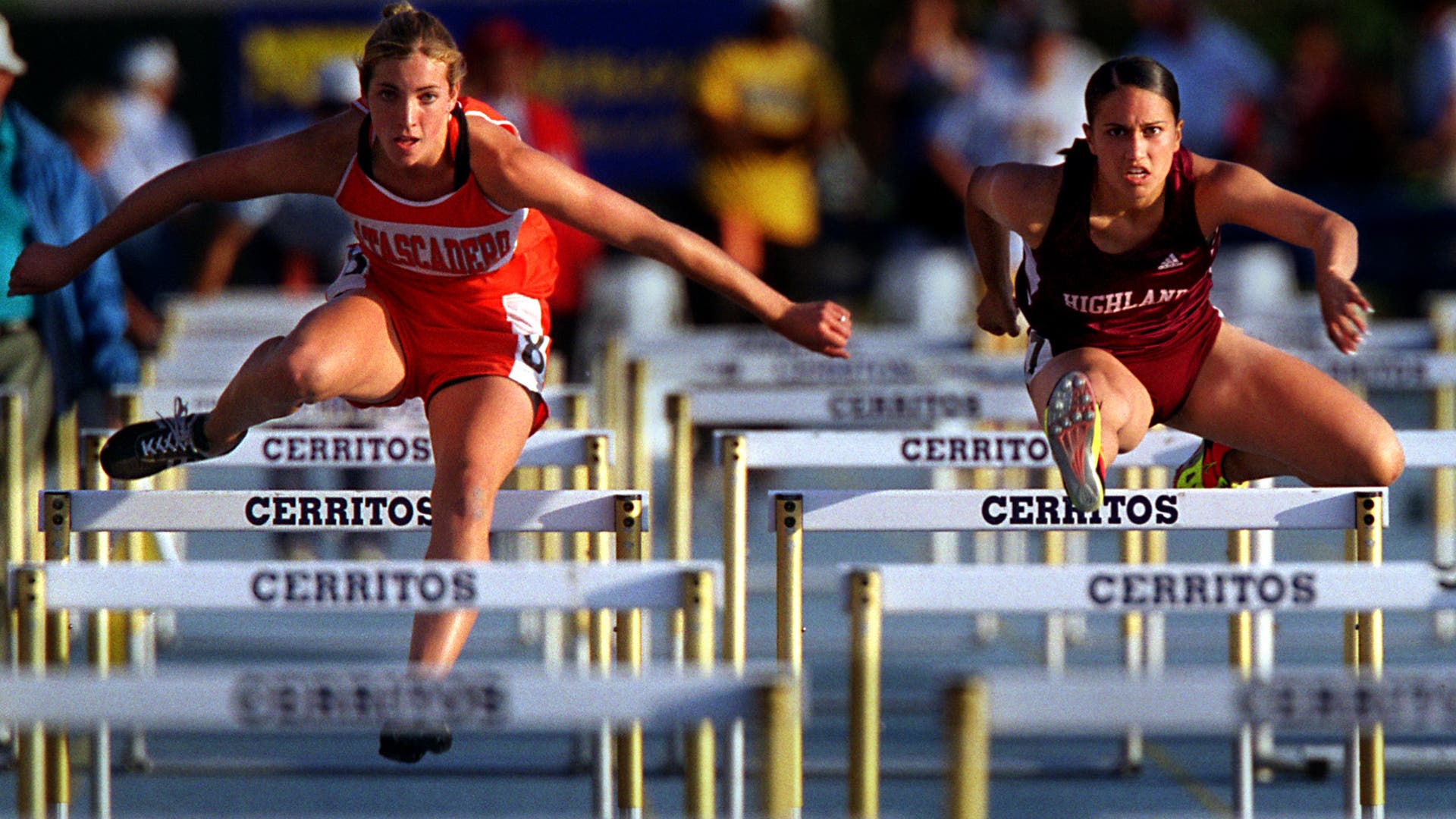 Gina Londono, right, of Highland, makes her way to a third place (15.42) finish in the women's 100meter high hurdlesduring the CIF Southern Section Track and Field Masters Meet held Friday evening iat Cerritos College.