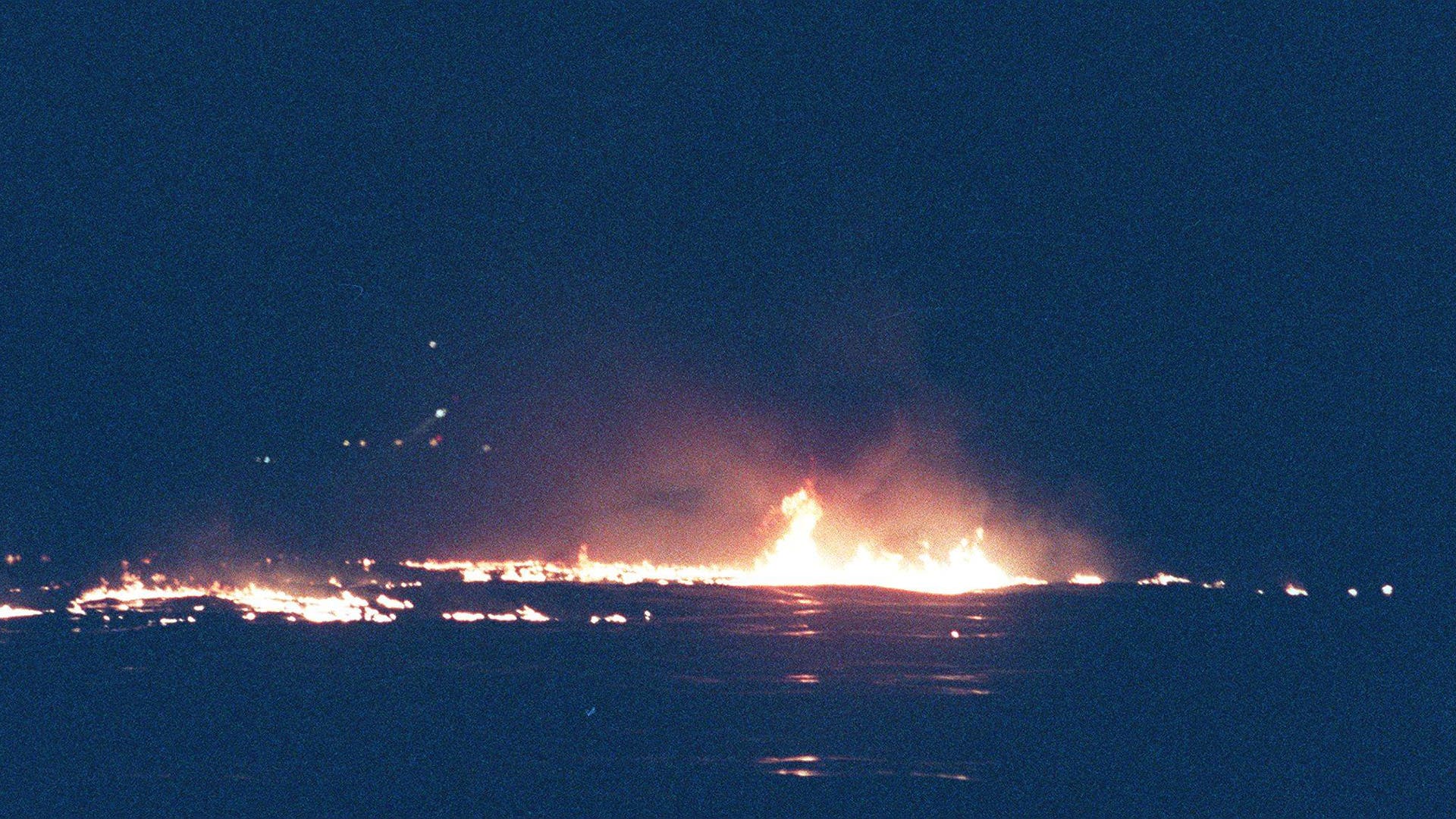 Flames from burning jet fuel on the waters off of Long Island from the TWA Flight 800 Boeing 747-100 aircraft that exploded on July 17, 1996 near East Moriches, New York.