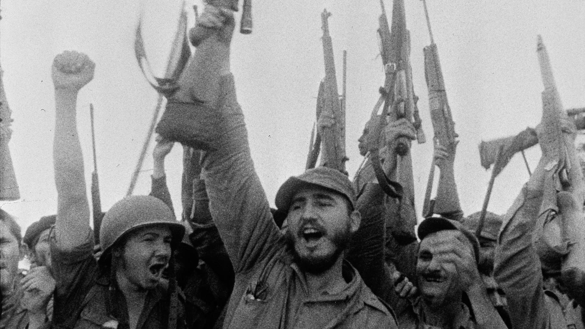 Cuban guerilla leader and future dictator Fidel Castro and associates as they cheer and raise their weapons and fists in the air on the CBS News Special Event 'Rebels of the Sierra Maestra,' Cuba, 1957. (Photo by CBS Photo Archive/Getty Images)