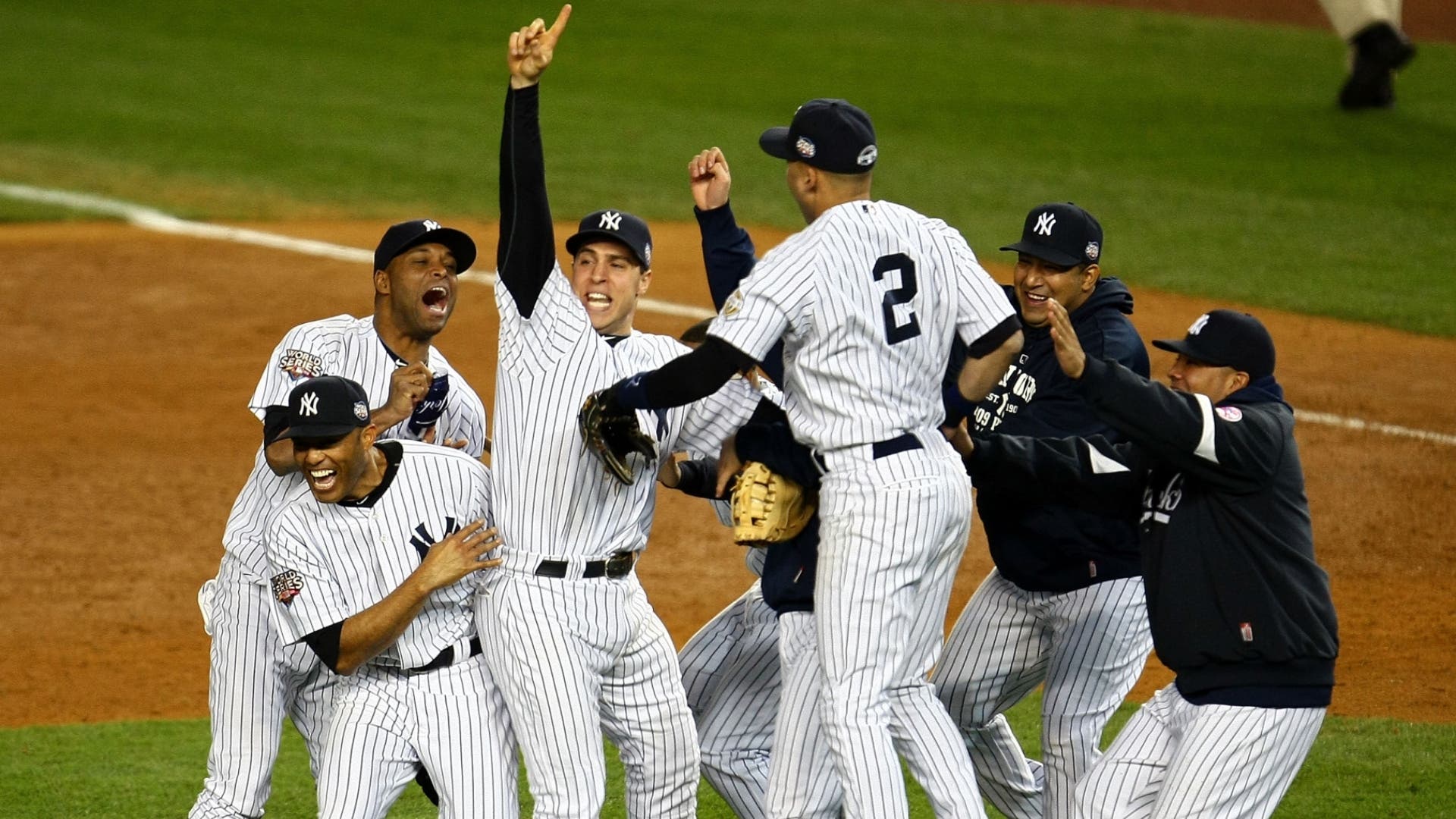 Damaso Marte, Mark Teixeira #25 (C) and Derek Jeter of the New York Yankees celebrate with teammates after their 7-3 win against the Philadelphia Phillies in Game Six of the 2009 MLB World Series at Yankee Stadium on November 4, 2009 in the Bronx borough of New York City.