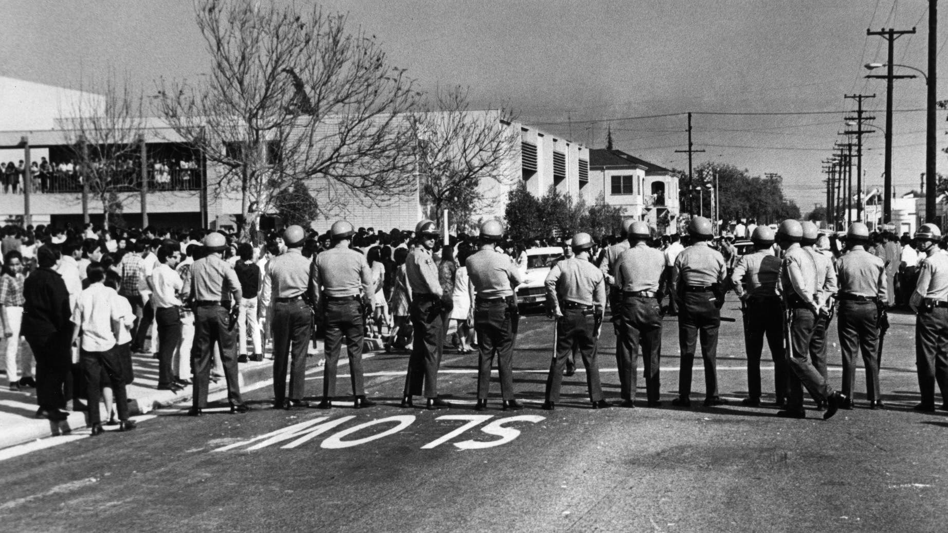 Sheriff's deputies form a line across street at Garfield High School during a Chicano student demonstration on March 5, 1968. Similar confrontations occurred at other schools.