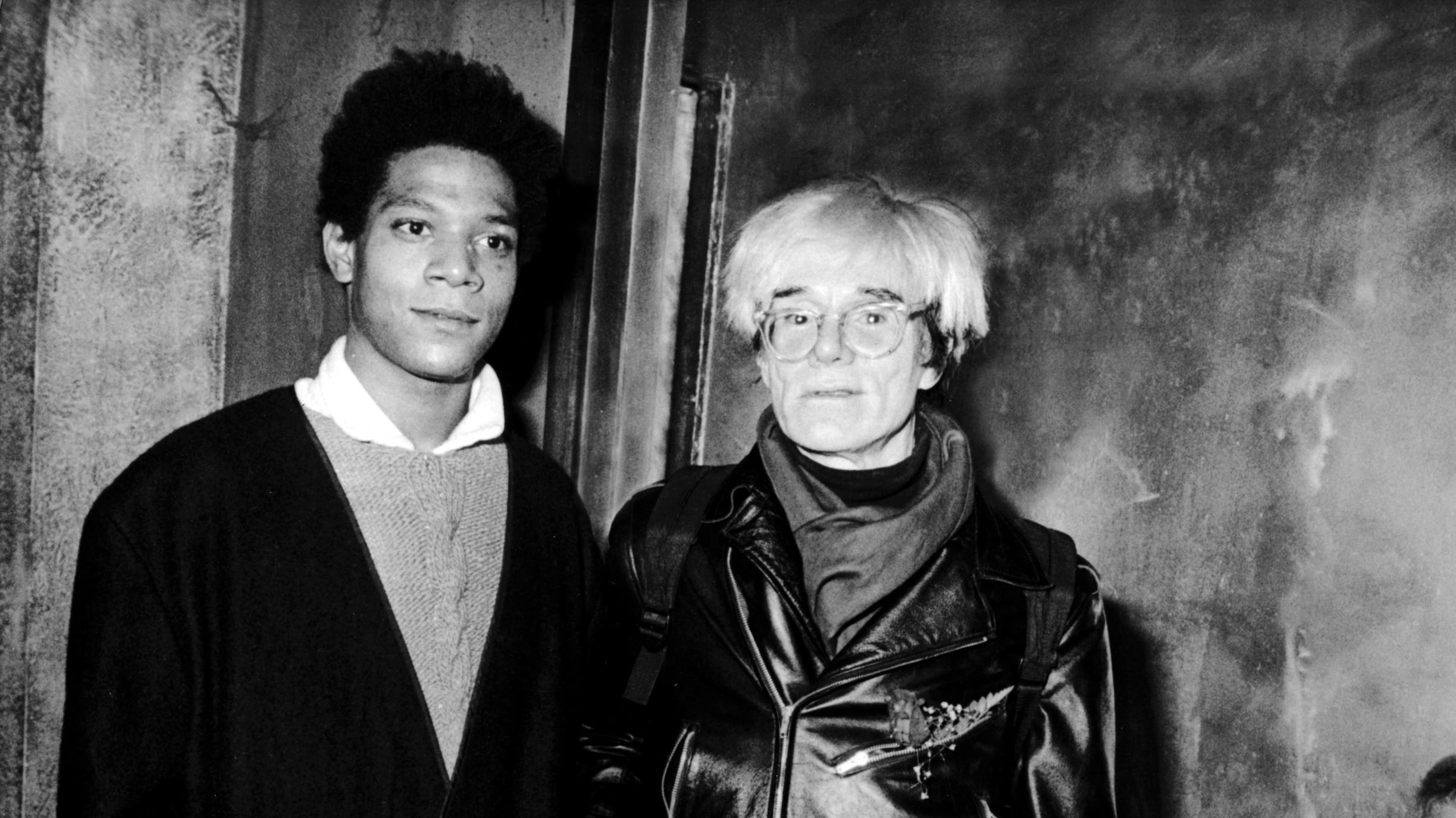 Jean-Michel Basquiat and Andy Warhol at a benefit for the Brooklyn Academy of Music on November 7, 1984 at Area Nightclub in New York City.