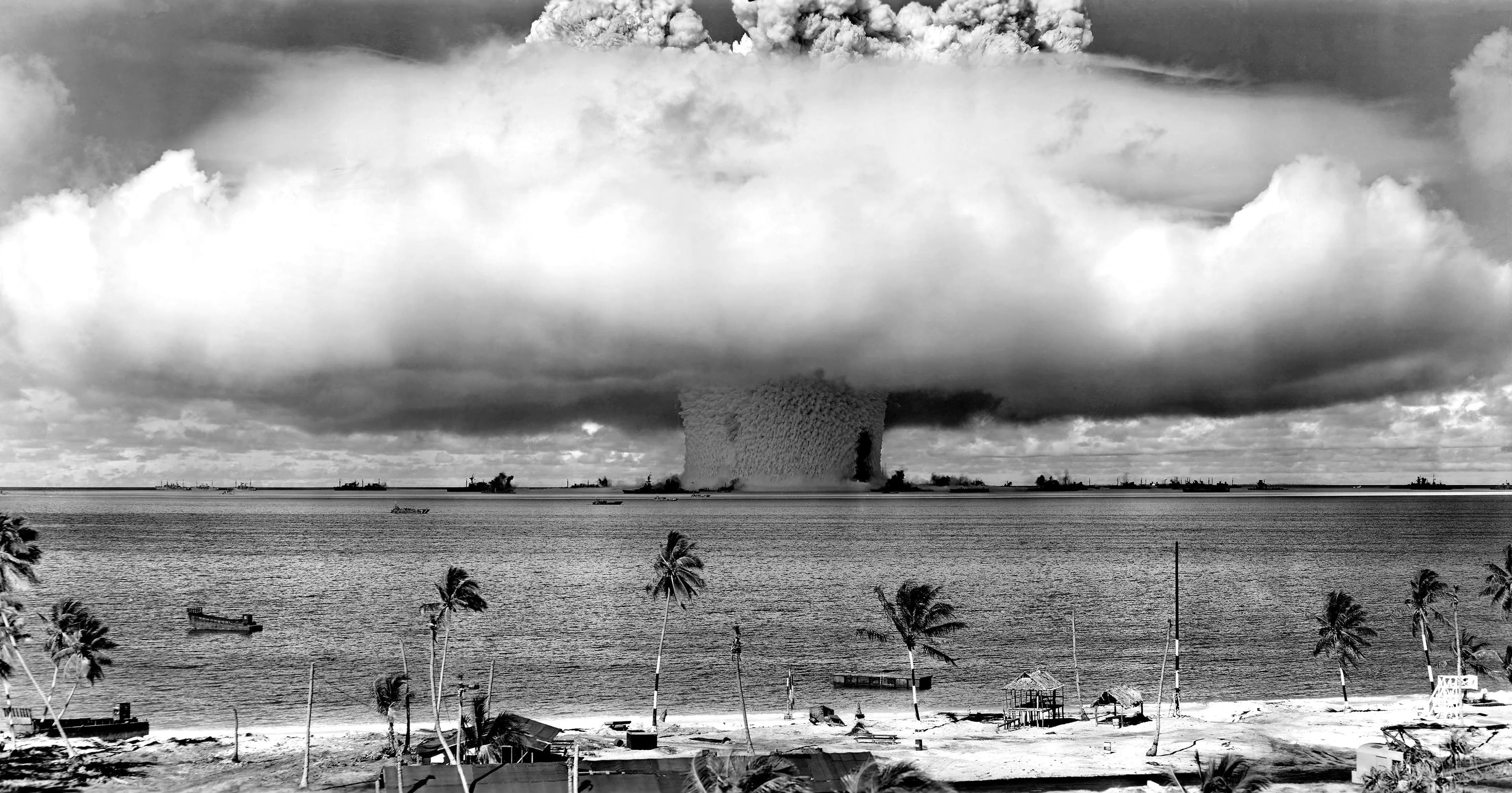 huge mushroom cloud exploding over a tropical island