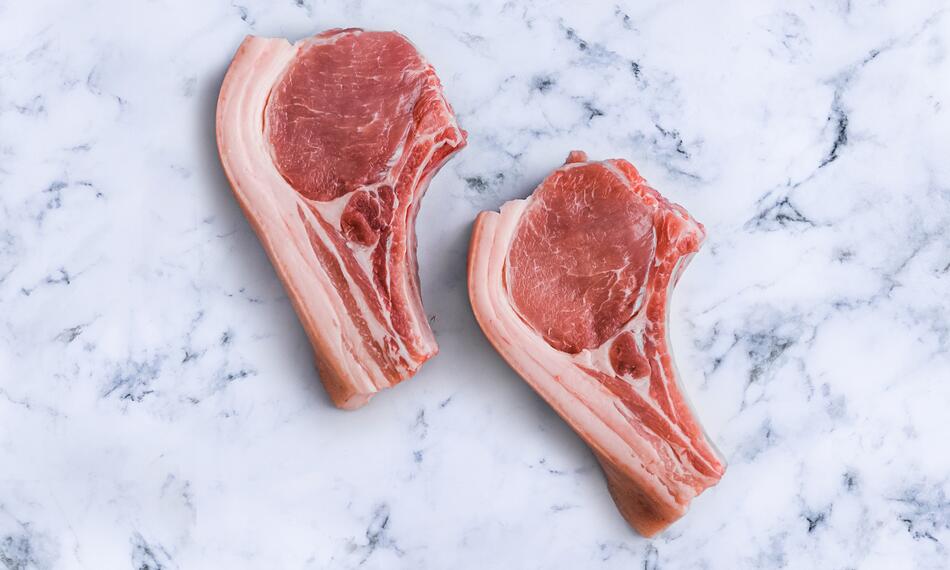 raw pork chops on marble 