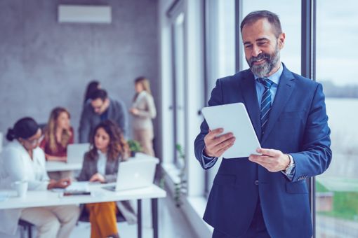 Man looking at tablet in an office