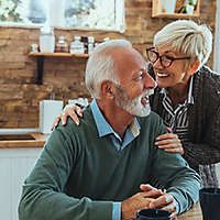 Elderly couple talking in kitchen