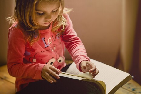 young girl reading a book