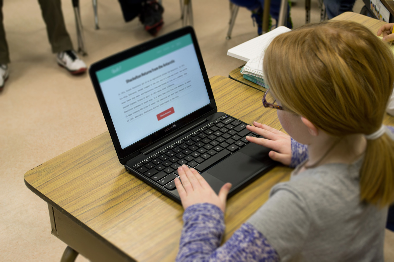 student viewing Quill.org on a laptop