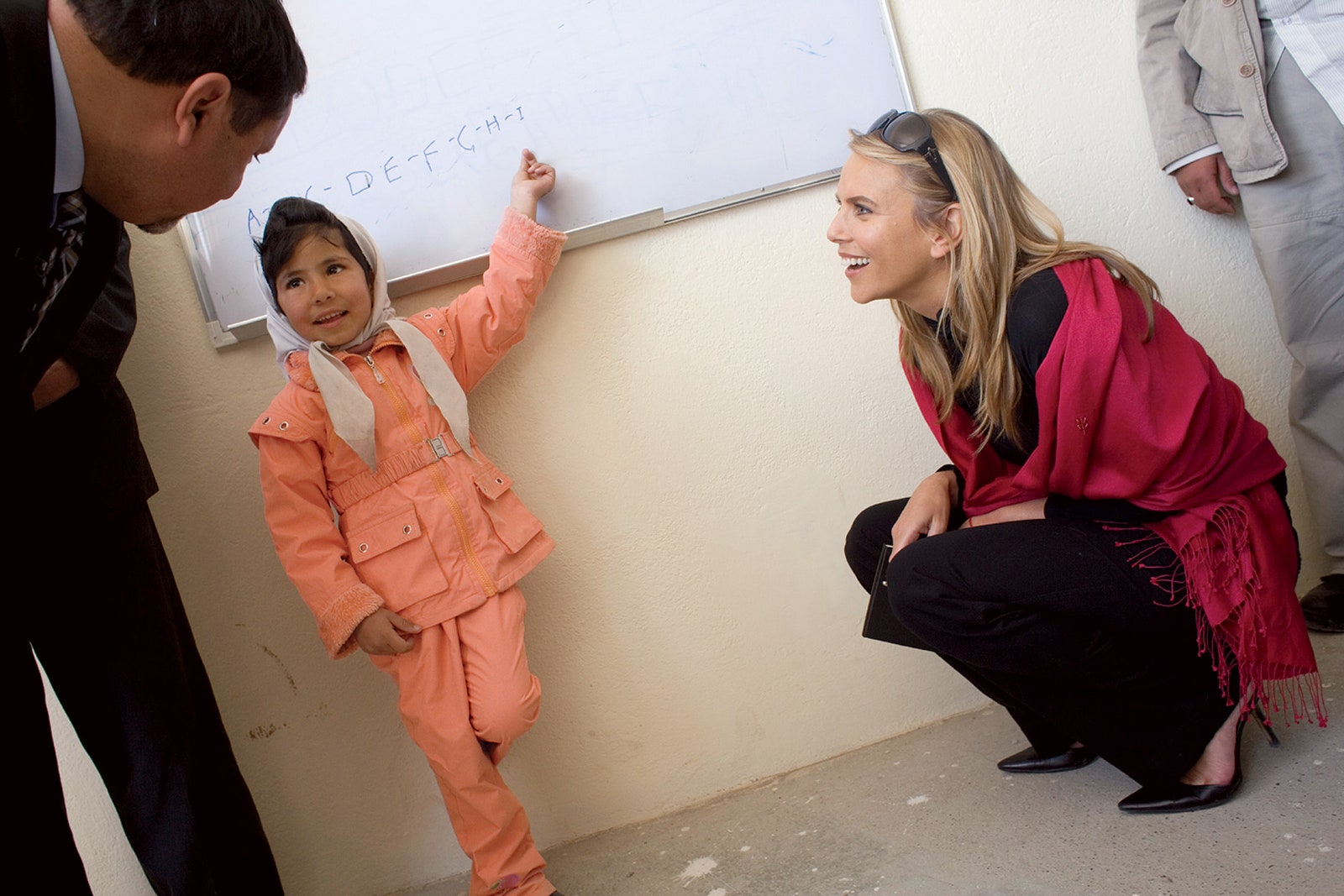 Image may contain Shoe Clothing Footwear Apparel Human Person White Board and Sitting