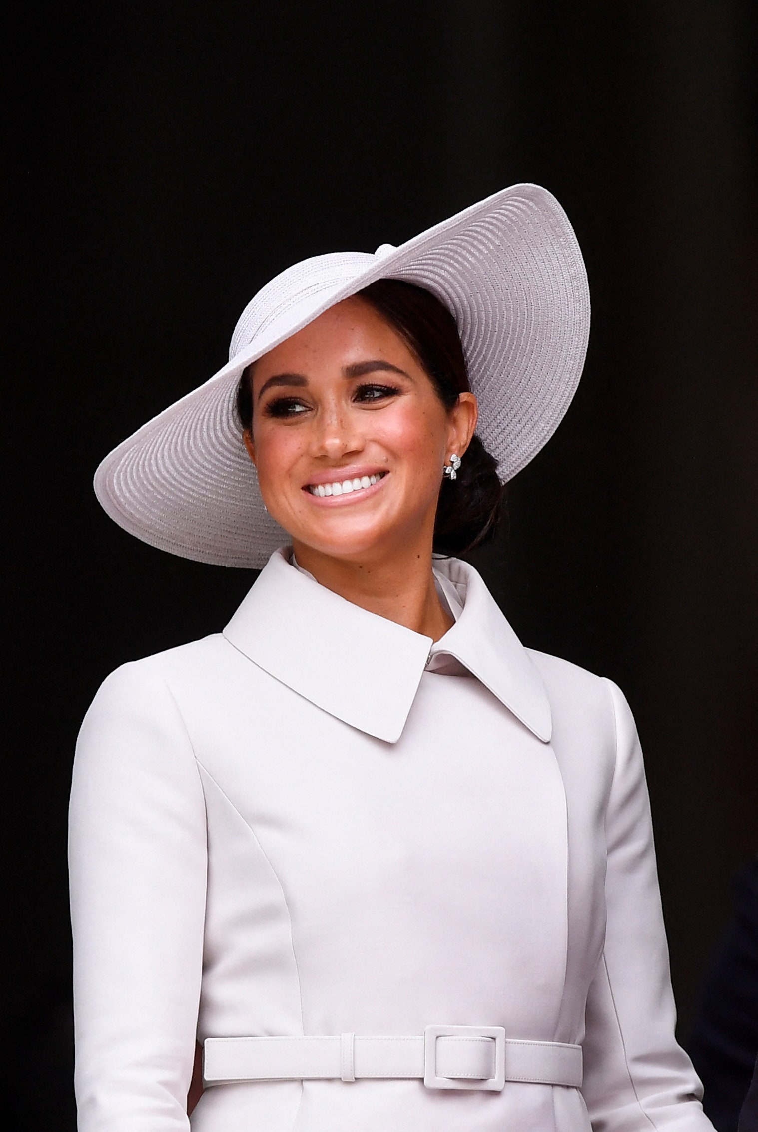 Image may contain Meghan Duchess of Sussex Face Happy Head Person Smile Dimples Clothing Hat and Adult