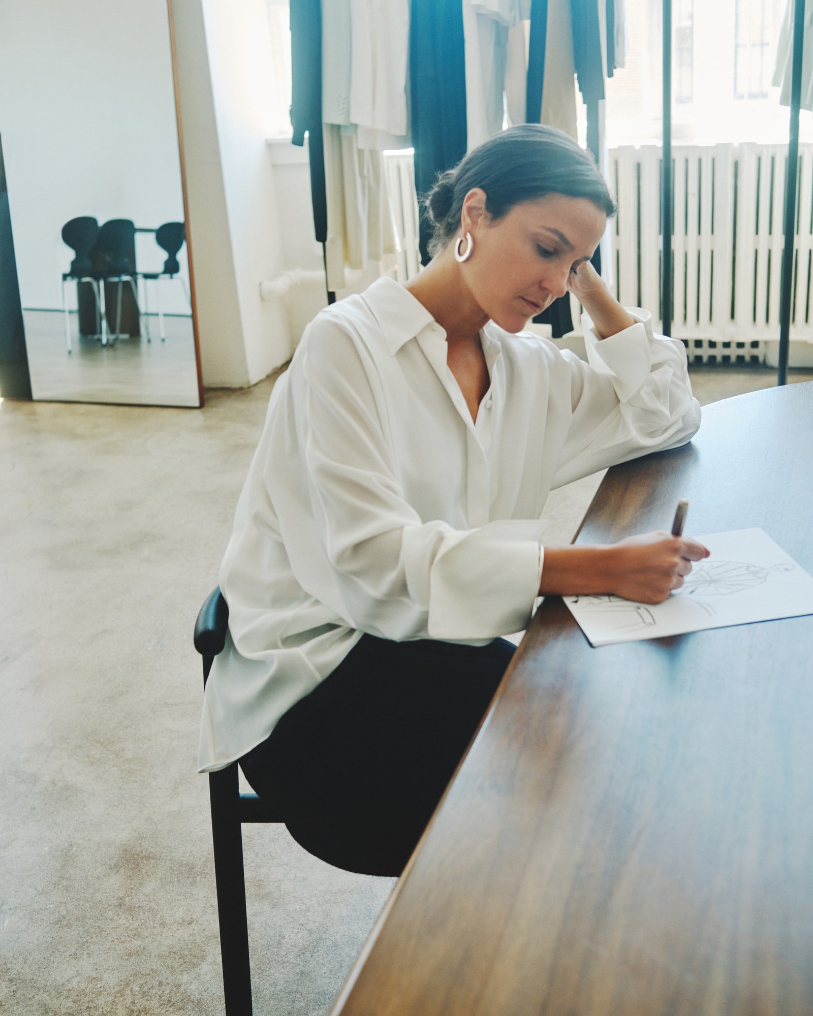 Image may contain Desk Furniture Table Adult Person Head Face Chair and Sitting