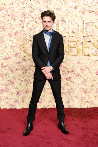 Image may contain Timothe Chalamet Clothing Formal Wear Suit Fashion Adult Person Standing Tuxedo and Accessories