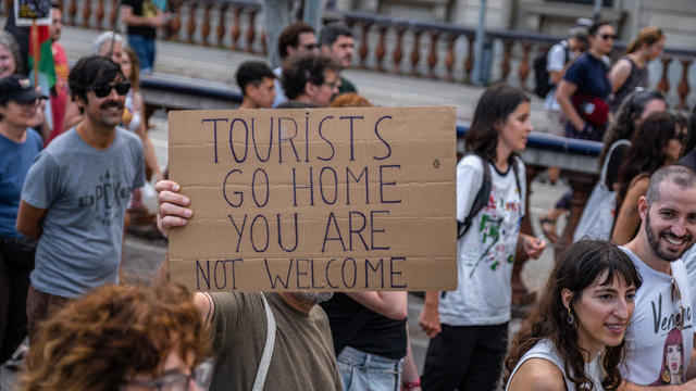 An anti-tourism placard is seen during the demonstration 