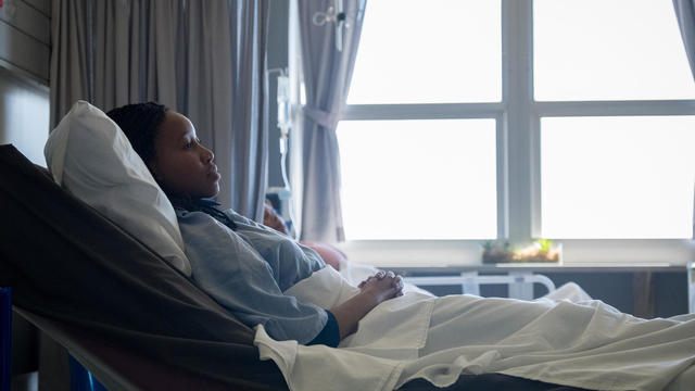 Sick patient lying in hospital bed 