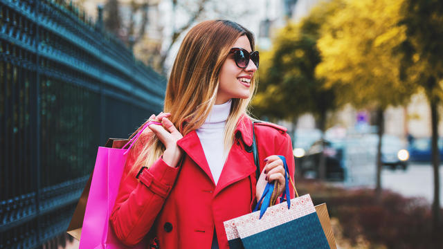 Happy woman in shopping. Consumerism, fashion, lifestyle concept 