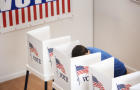 Caucasian voter voting in polling place 