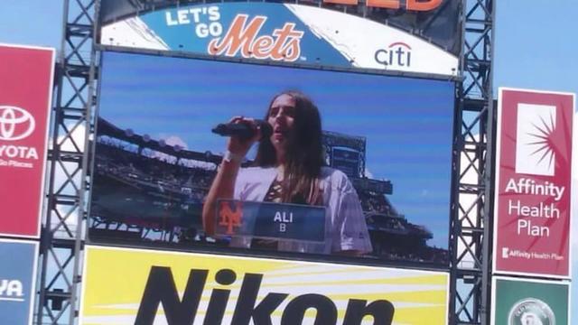 A photo of the jumbotron at Citi Field. Ali Berke is on the screen performing the national anthem. 