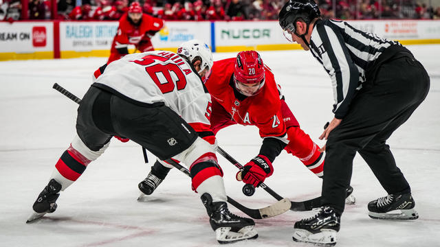 Sebastian Aho #20 of the Carolina Hurricanes faces off against Erik Haula #56 of the New Jersey Devils during the first period at Lenovo Center on October 15, 2024 in Raleigh, North Carolina. 