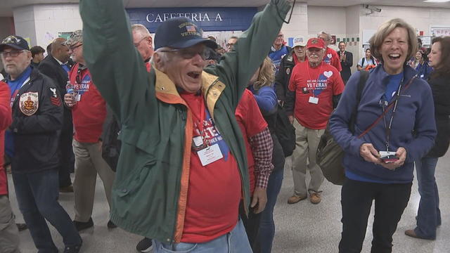 A veteran raises his arms and smiles in celebration at the event 