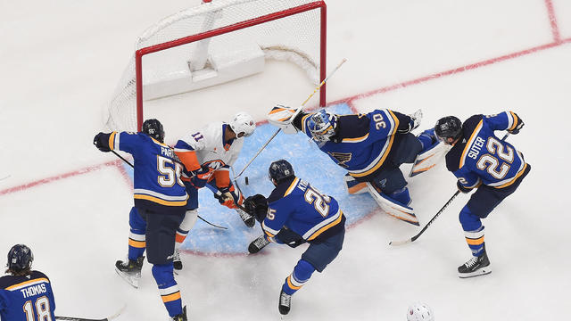 Colton Parayko #55 Jordan Kyrou #25 Joel Hofer #30 and Ryan Suter #22 of the St. Louis Blues defend the net against Anthony Duclair #11 of the New York Islanders on October 17, 2024 at the Enterprise Center in St. Louis, Missouri. 