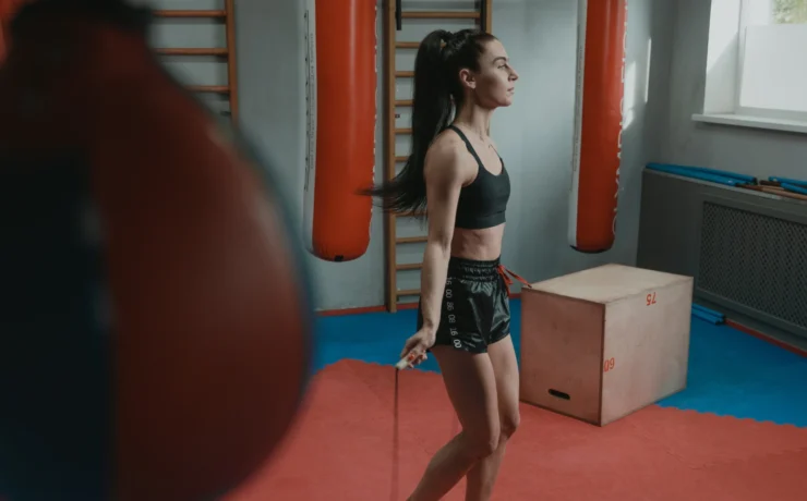 Woman working out in gym, jumping rope