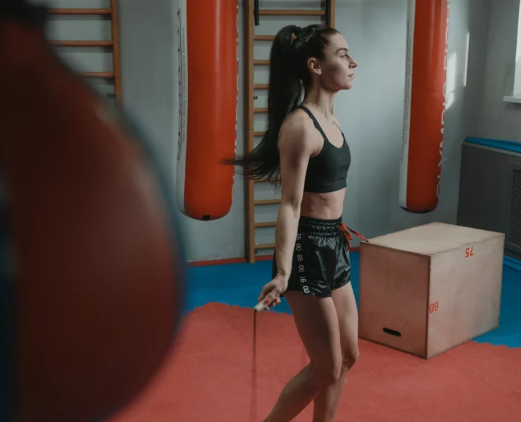 Woman working out in gym, jumping rope