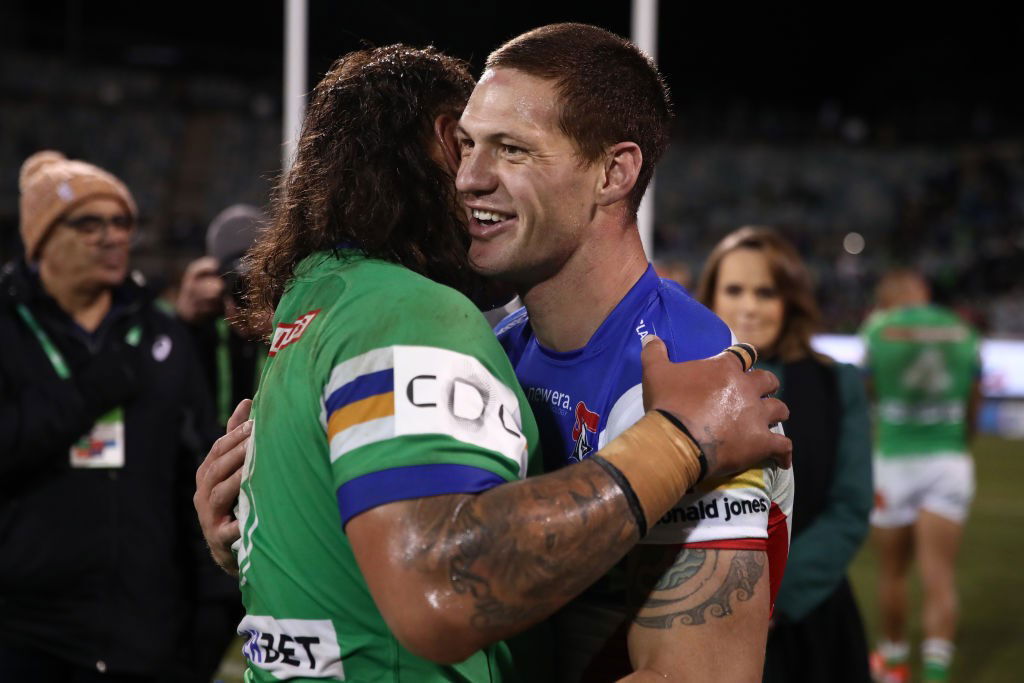 Josh Papali'i and Kalyn Ponga hug after an NRL game between the Raiders and Knights.