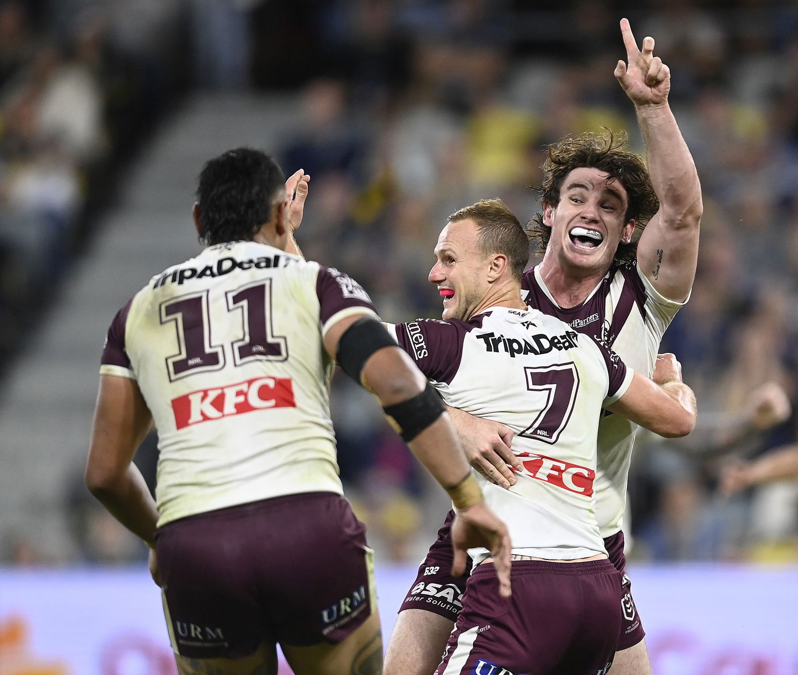 Manly Sea Eagles players celebrate with Daly Cherry-Evans after winning an NRL game.