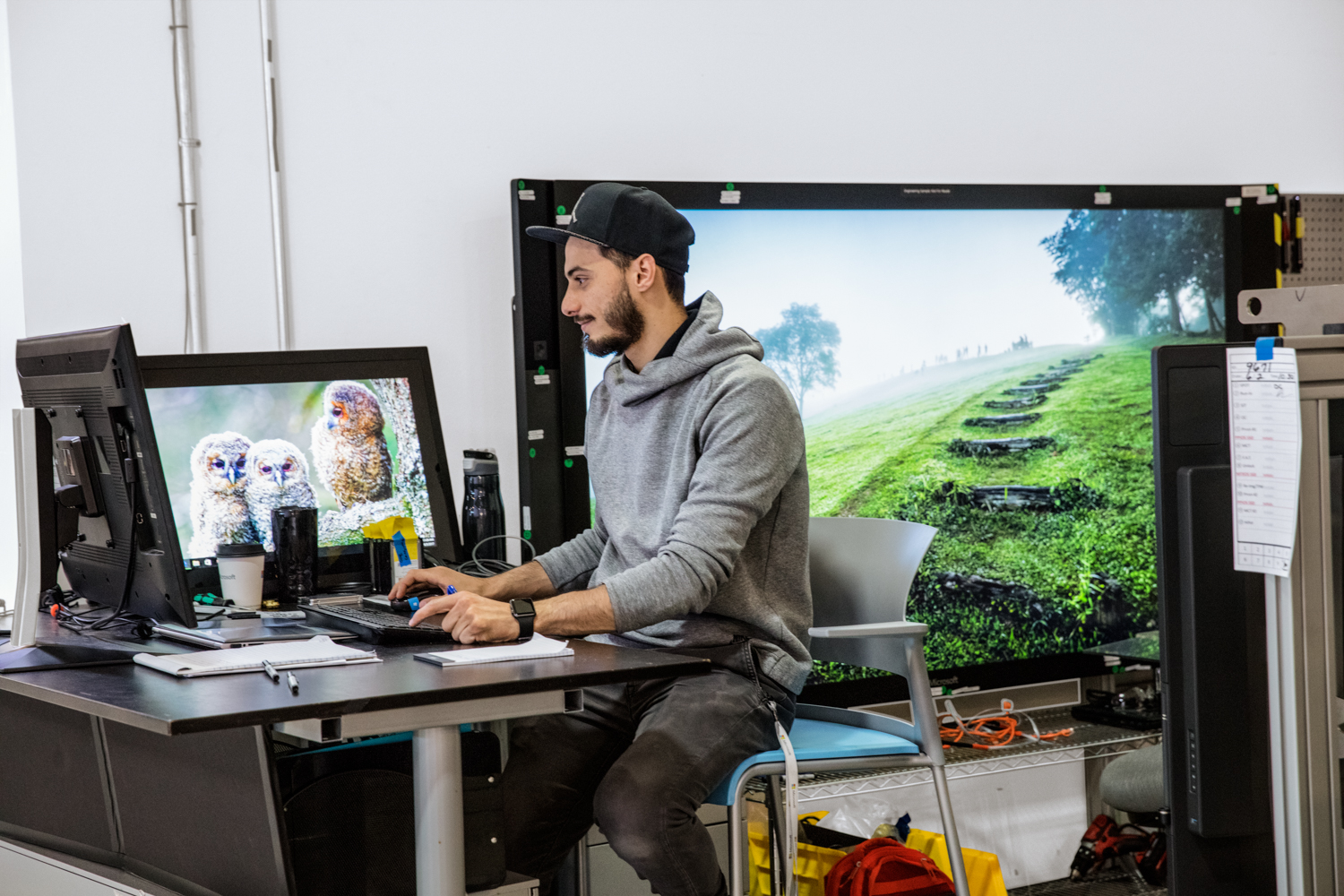 a man sitting at a desk in front of a computer