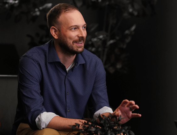 male employee smiling and talking